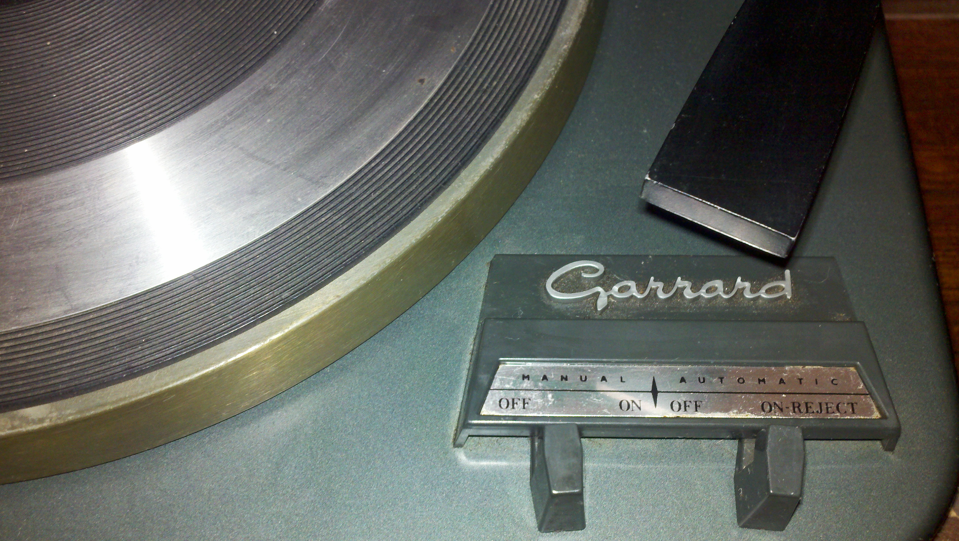 Many record turntables featured a semi-automatic reject mechanism